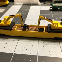 Well car with two 245G LC Excavator with load of railroad ties
