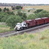 BNSF MOW Truck pulling (or being pushed?) three ballast cars downgrade on the Curtis Hill, OK, Transcon line:  Aug 2009