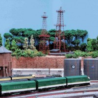 A Closeup View Of The Finished Scene; Retaining Wall & Oil Derricks

 The oil derrick on the left is a brass kit. The oil derrick on the right is a Laser Cut building kit. Both kits are very delicate and require careful construction. These oil derricks were on the "original" JJJ&E.