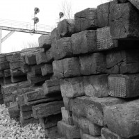 Old railroad ties stacked alongside the mainline next to the Rosemont signal at Lexington, KY