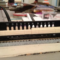 A Micro Trains N scale model of a Western Pacific Centerbeam flat car.