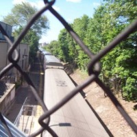 MBTA Commuter Cars Through Chain Link Fence