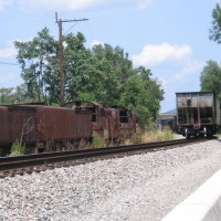 Empty Coal Train Passing Scrap Yard
