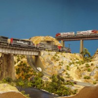 050521 (n scale) An SP manifest passes under a Santa Fe hotshot