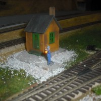 Checking his watch to see if the train is on time
