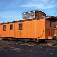 Old wooden caboose, less trucks, parked in Woodsville NH