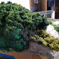 Granite Mountain helix lid has trees on the edges but is mostly foam painted and covered with foliage.