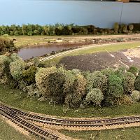 Refurbished trees behind settling ponds and in front of coal yard