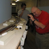Trainmaster Wagner collects photos of the wreck.