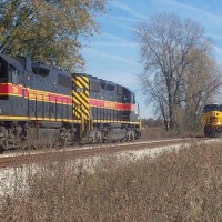 Eastbound train with an SD38-2 leader meets the Rock Island turn with a GEVO leader at North Star in Wilton, IA--October 29, 2008.