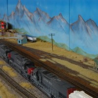A long westbound SP freight powers up and departs under the green at Anson Gantry. Noisy!