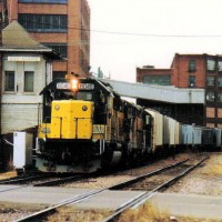 CNW 8048 rolls past the Eau Claire Tower.