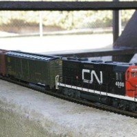 GP35 CN 4000 - a more photogenic view of my first repaint/detailing job. Used to be a stock Athearn in Southern Pacific garb, bought it used at a train show/sale in Kemptville, Ontario, for $25. 

Added the antenna on top of the cab, the cab bell, some hoses on the pilot (#26 insulated wire!). Most fun with trains I have had in, well, 30 years...

Had to grind out the ribs on the inside of the body to clear the flywheels - the loco didn't run with the body on... Makes me wonder if someone dropped a geep shell on a cab-unit frame?