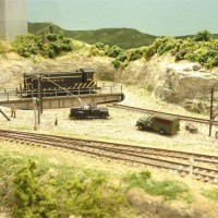 Sand Springs Railway - West end of West Tulsa interchange, Occasionally we have "all steam day" on the Sand Springs layout and a turntable is used to turn the engines.  A crew of pole setters are working on telephone poles.  The wench in the truck was kitbashed with a diesel truck fuel tank and a few pieces of styrene.  The telephone poles were scratchbuilt from brass.