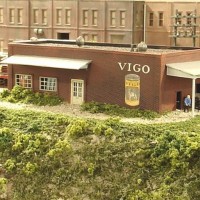 Sand Springs Railway - Vigo Dog Food - The Vigo can for the sign was a black and white photo that I copied from my high school yearbook, then with yellow colored pencil I changed it to the family yellow label, which I remember from my youth.  The structure is scratch built with Holgate Reynold paper covering the styrene.  The turbines are beads from a hobby store.