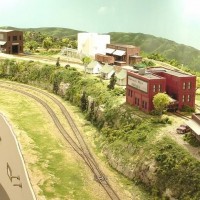 Sand Springs Railway - Overview of Sand Springs east.  The skyboard is 1/8th inch masonite.  Primed white, painted blue.  The mountains are painted solid (green of you choice) a fan brush, just tipped in light green apple looking color, makes the ridges and valleys.  Very easy, try it on a scrap to get the technique that soots you.