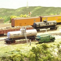 SS Rwy - Yard and Service Facility 

Fuel Service - Modified fuel truck by cutting open back panel and using flexible wire as the fuel hose.

Skyboard - When drilling hole for the switch signal, I damaged the skyboard, with just a little paint, it became a tower in the distance.