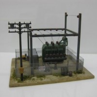 Side view of my little substation that'll sit on the hillside just above the tracks. Not an exact replica of the substation that exists at East Portal but close enough based on the distant pics I had available. I used parts of an old Model Power kit but the GMM chainlink fence really makes the scene complete