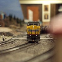 UP 8242, an SD90 heads up a trio of SD90s hauling a line of Ethanol cars up the hump on the Sun N Sand Layout. Picture taken at ground level.