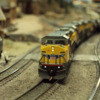 UP 8242, an SD90 heads up a trio of SD90s hauling a line Ethanol cars up the hump on the Sun N Sand Layout. Picture taken from elevation level.