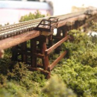 Wooden trestle close-up on details. It's Micro Engineering Bridge flex track complete with guard rails and little platforms. It think I did a good job (for a first try ever) but I won't claim a medal for this one.