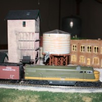 Another view of Canadian National diesel in front of the water tower and coaling tower.
