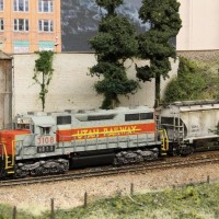 HDLX (former UTRR) SD35 pulling a cut of hoppers from the grain elevator siding.  BNSF-BenZach Sub