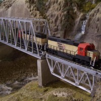 This crossing used to be spanned by a double track HO bridge. Now the OWL crosses on a single track, N-scale combination of bridges.