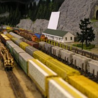 The busy Yardmaster not only has to deal with through trains, his yard is also totally plugged with loaded and empty log cars and two locals. Our Yardmasters usually do a very efficient job to get the trains out and earn money for the Railroad!