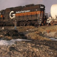 Guilford Rail System SD-26 leaving the causeway