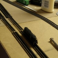 Used MTL sectional track to connect the table. The right side of the curved sectional track has half joiners to slide over the track to the table. Put in the joiner tracks so I could try out the speedometer. Digital display on the side for the inside track.