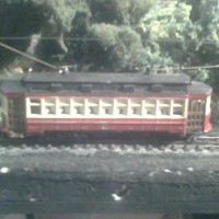 Mod 1
Upper windows filled in and ventilation equipment added. Just bits of balsa strip in windows and 1/16" plastic square strip for vents. Repainted in Chicago Surface Lines colors custom decal added. Functioning trolley poles added.