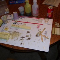 Casting the parts to build U.P. water aux. cars. Right of the cardboard are 3 shell castings & below those are 4 bottom castings. It takes 1 2 part RTV mold and 2 1 part molds to make this water car. The parts you see here have now been painted. 5 days to build so far. I am waiting on parts to come via UPS.