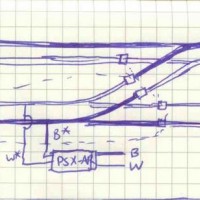 An idea for wiring a cross-over on a T-Trak module while preserving T-Trak wiring standards.