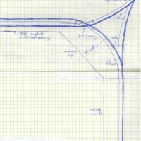 T-Trak to oNerTrak wye corner idea for interface between Oregon-American mill and lines to the woods. Heavy blue-line rail represents blue-polarity plug line from T-Trak standards. Blue-to-the-outside standard from T-Trak precludes necessity of auto-reverser at wye.