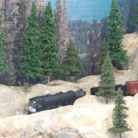 SP #4276 AC-12 Cab Forward, coming out of high Sierra tunnel with freight load