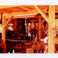 Pomeroy Steam Logging Weekend: This much smaller donkey was being used as the loader, operating the heel boom loader attached to the spar tree. In the foreground is a belt-driven saw that was used to knock pieces of wood to length for use as fuel in this smaller donkey.