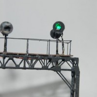 Signals on bridge, one showing green