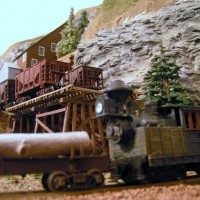 The old teakettle Climax pushes log cars past the the mine.