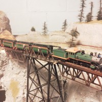 This was my big disaster. The high bridge that the engineers never got quite right. Going over is C.M.&B. No. 1. Its an Athearn Mogul pulling some old Roundhose Passenger Cars.