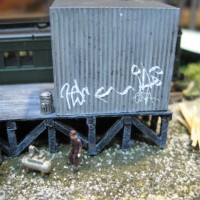 GRAFFITI DECALS ADDED TO METAL SIDING.