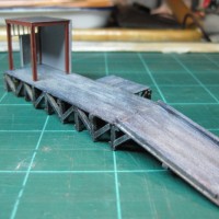 MAINTENANCE SHED PAINTED AND GLUED TO PLATFORM.
