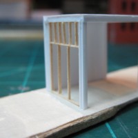 MAINTENANCE SHED CONSTRUCTED WITH H-BEAMS AND STYRENE METAL SIDING AND PLAIN STYRENE.