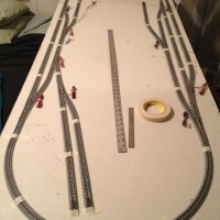 Okay! Got the track back down, somewhat centered and taped down. Next will come tracing the track so I can get started on the roadbed.