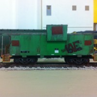 BNSF Way car. I see one of these ate the port from time to time. I started this project 15 years ago. I had it painted in green and yellow and had started the safety rails..