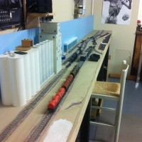 I'm making progress, I installed and painted the sky boards over the weekend. I am also adding another extension for staging track and a passing siding on the lead in to staging. The layout is now almost 16' long. The staging will add another 4 feet in length. I will eventually extend another 15 feet to another corner of the garage, this will be Tiger Switch with the tie-in to the BNSF main line at Catoosa Oklahoma.