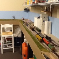Looking East towards BNSF interchange. I am adding shelving over the layout. This will also serve to support the upper valance. It will be painted to match the blue back board. I will also paint the wall above the sky board to match. At some point I add lighting behind.
