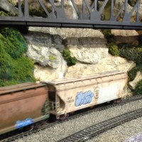 ACF grain hoppers, left hopper rusted with rail painter and chalk.