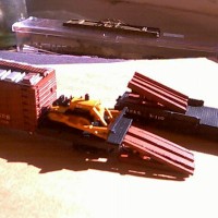 Companion flatcar carried the ramp to unload the dozer .