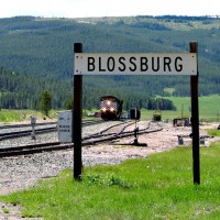 Blossburg, MT station sign frames a pair of light SD70ACes